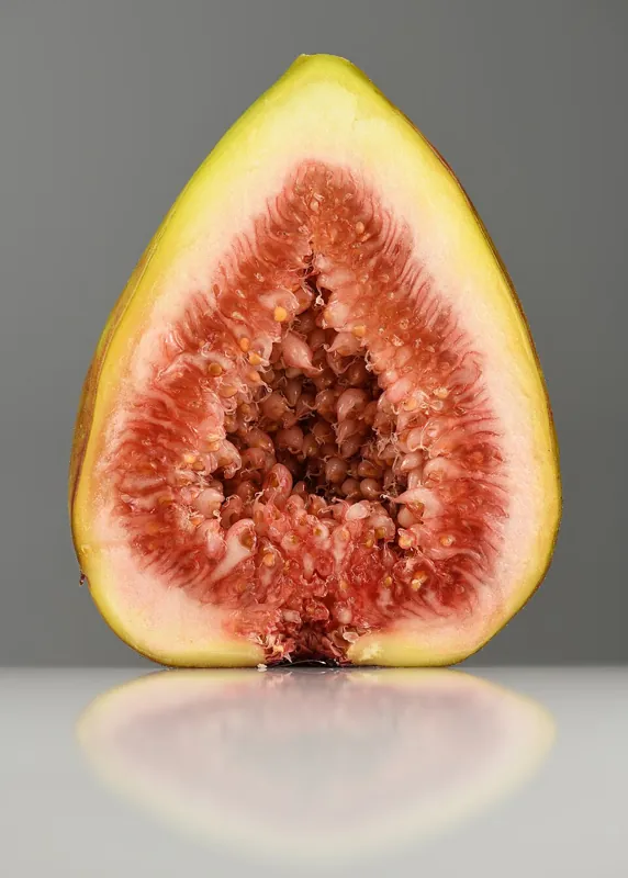 A fig cut in half, showing its red interior